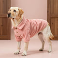 Custom pink corduroy dog shirt with classic collar and brown button closure.